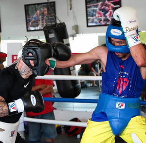 Two professional boxers sparring each other using Winning Japan headgear, boxing gloves, and groin guards